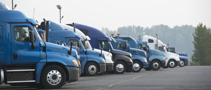 commercial trucks lined up on road